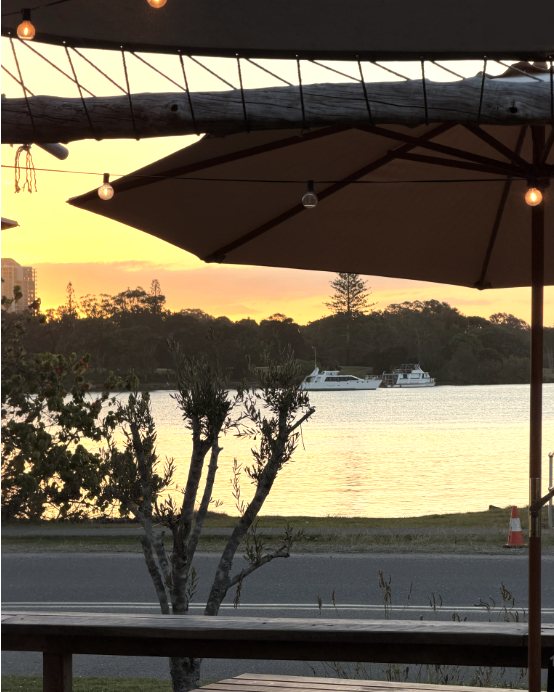 Sunset over the river from under the umbrellas