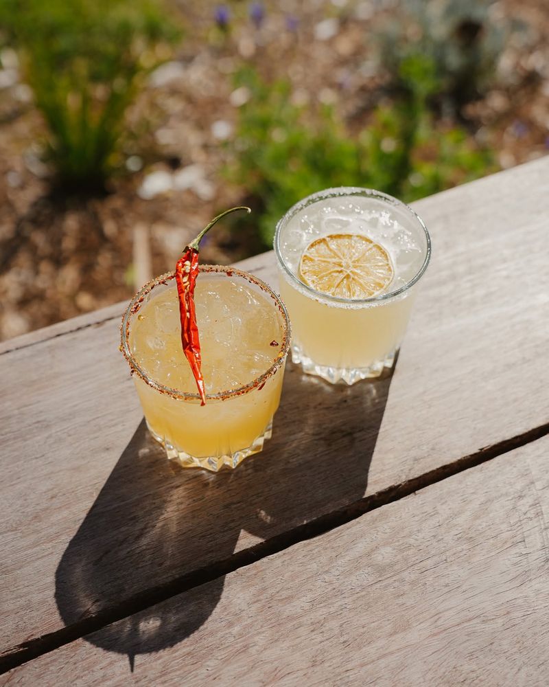 A spicy and a classic margarita on a timber table